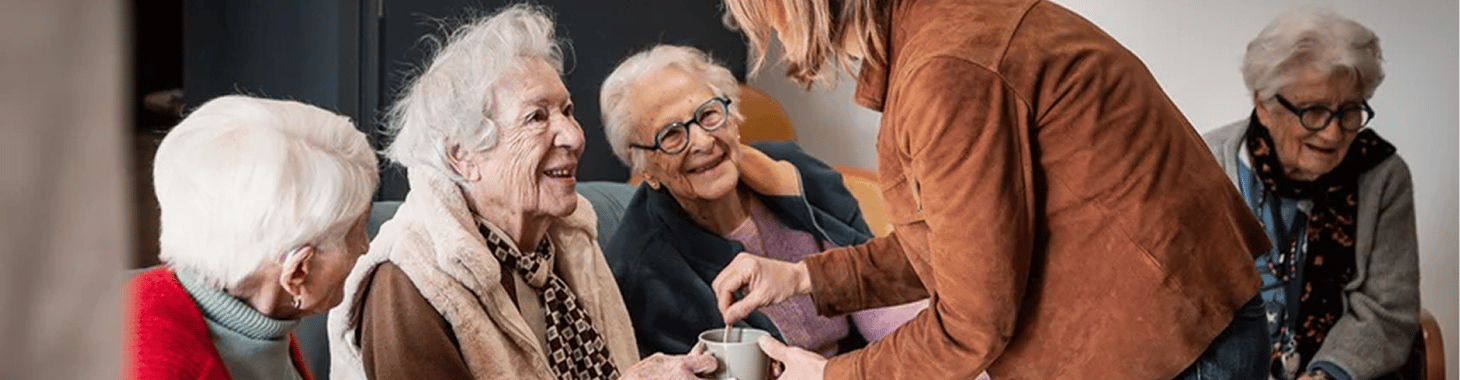 Une soignante prend le café avec des résidentes à la Maison de Blandine Une soignante prend le café avec des résidentes à la Maison de Blandine