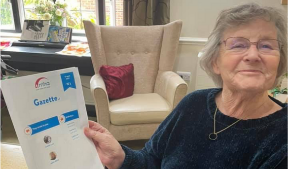 A MHA resident with her Famileo gazette.png